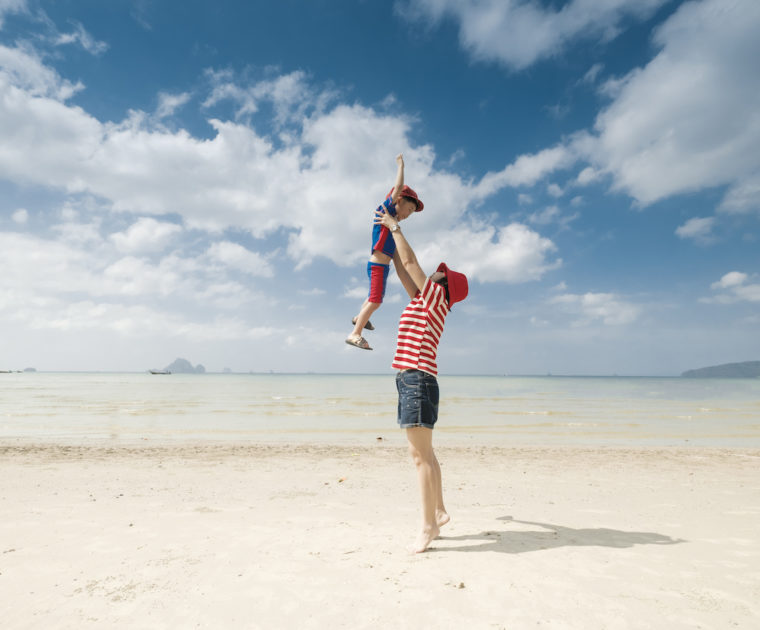 A mother and son playing on beach outdoors Sea and Blue sky in happy day