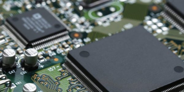 Closeup of electronic circuit board with CPU microchip electronic components background