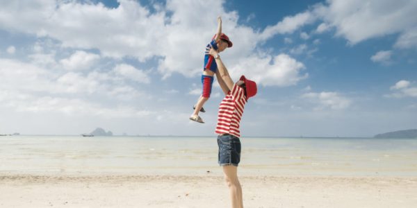 A mother and son playing on beach outdoors Sea and Blue sky in happy day